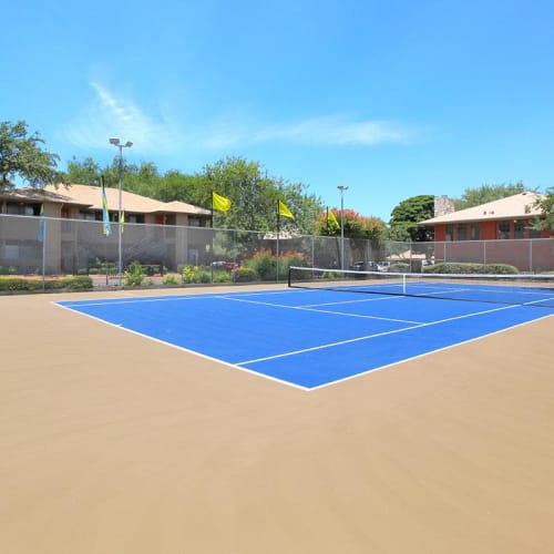 An outdoor tennis court at The Granite at Tuscany Hills in San Antonio, Texas