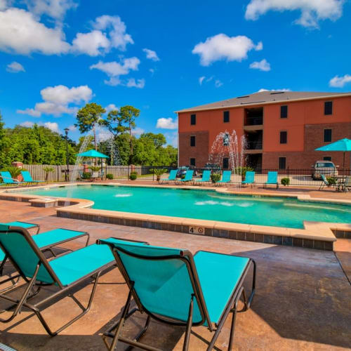 Lounge chairs by the pool at Oceanaire Apartments in Biloxi, Mississippi