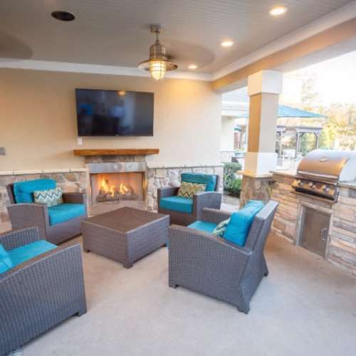 Outdoor fireplace and seating area at The Asher at Sugarloaf in Lawrenceville, Georgia