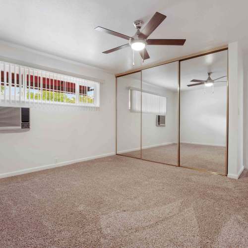 Bedroom with a ceiling fan at Lorenzo Commons in San Lorenzo, California