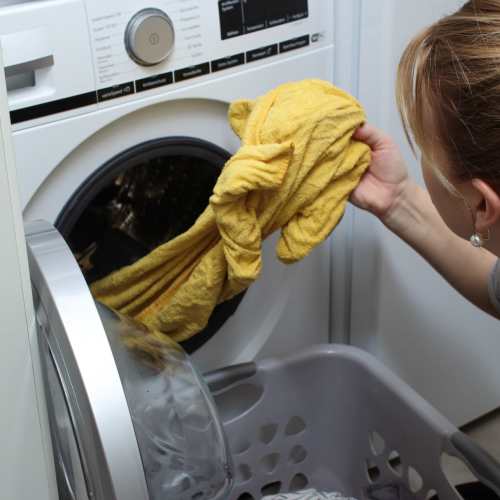 Resident doing laundry at Morado Bothell in Bothell, Washington