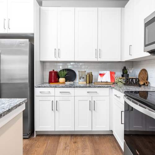 Kitchen with white cabinetry and stainless-steel appliances at The Station at San Marco in Jacksonville, Florida