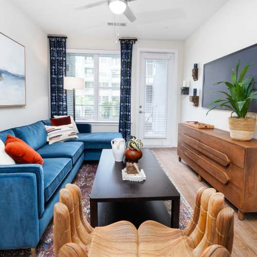 Living room with ceiling fan in a model home at The Station at San Marco in Jacksonville, Florida