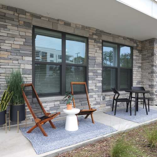 Outdoor patio with intimate seating at The Residences at Enso in Jacksonville, Florida