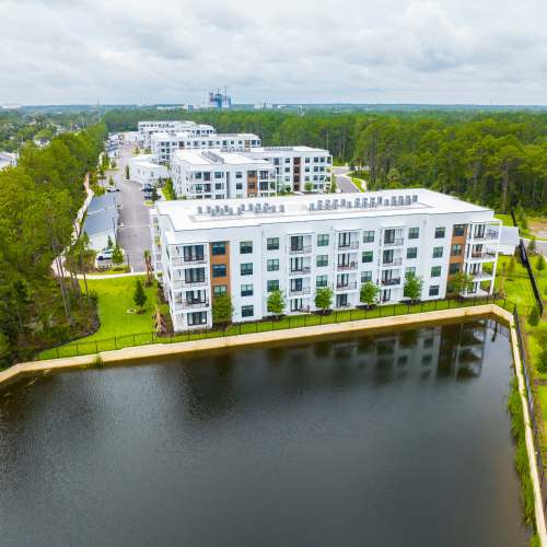 Apartment complex and nearby lake at The Residences at Enso in Jacksonville, Florida