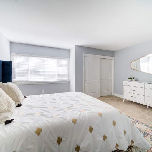 Bedroom with a bright window at The Trails of North Hills in Raleigh, North Carolina