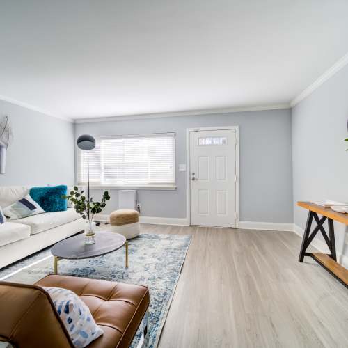 Apartment living room with wood flooring at The Trails of North Hills in Raleigh, North Carolina