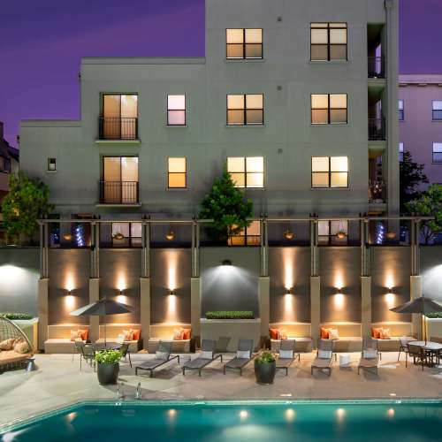 Pool and lounge chairs at night at 1801L Apartments in Sacramento, California