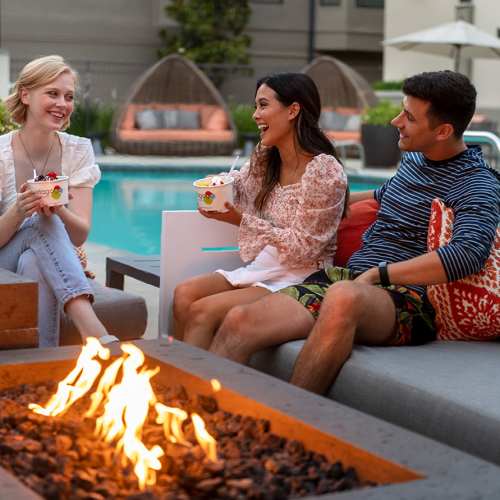 Residents hanging out by the firepit at 1801L Apartments in Sacramento, California