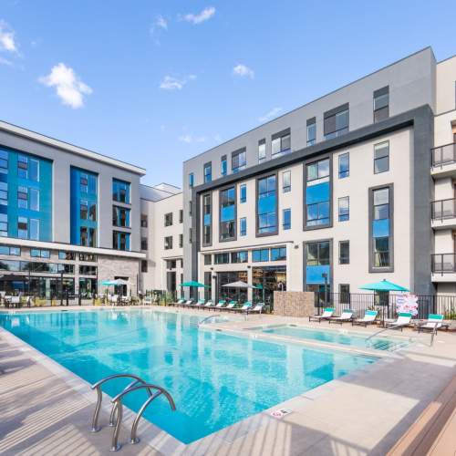 Lounge chairs by the sparkling swimming pool at Reno Experience District in Reno,