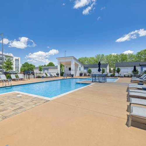 Resort style swimming pool with relaxing beach chairs at Mosby Bridge Street in Huntsville, Alabama