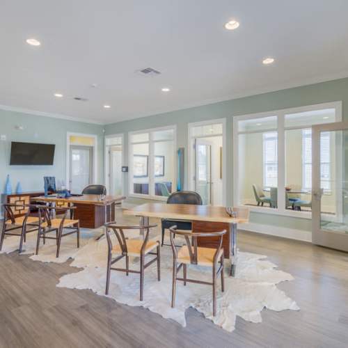 Tables and chairs in the community clubhouse at Reserve at River Place in Youngsville, Louisiana