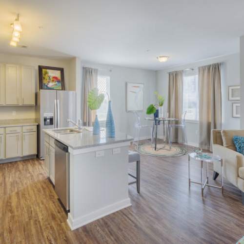 An apartment kitchen and living room at Reserve at River Place in Youngsville, Louisiana