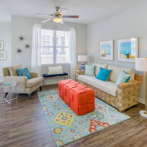 A furnished living room and ceiling fan in an apartment at Reserve at River Place in Youngsville, Louisiana