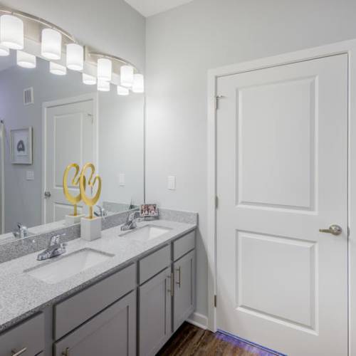 An apartment bathroom with plenty of cabinets at Reserve at River Place in Youngsville, Louisiana