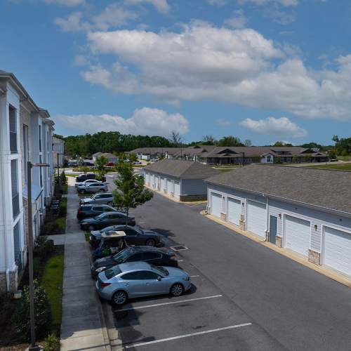 Parking spaces in front of an apartment building and garages at Reserve at River Place in Youngsville, Louisiana