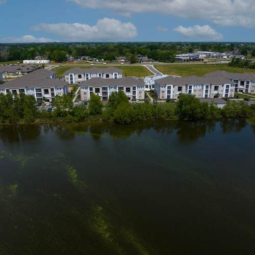 An aerial view of the community and surrounding pond at Reserve at River Place in Youngsville, Louisiana