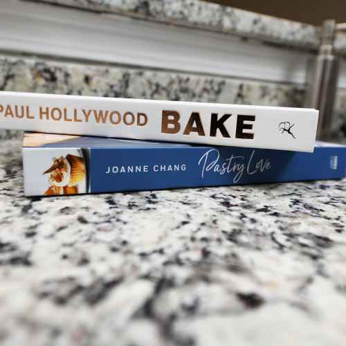 A kitchen counter with two cookbooks stacked in a kitchen at Nova at Biltmore Park in Arden, North Carolina