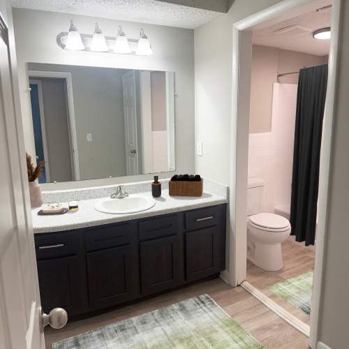 Carpeted bedroom with ceiling fan at Candlewood Apartment Homes in Nashville, Tennessee