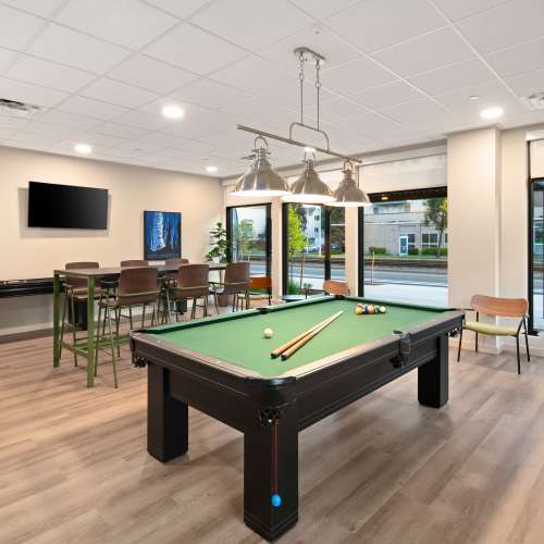 Game room with Billiards Table and Shuffle Board at Traditions at Hazelwood in Portland, Oregon