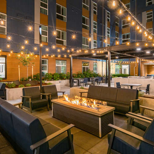 Nighttime photo of community courtyard and fire pit at Traditions at Hazelwood in Portland, Oregon