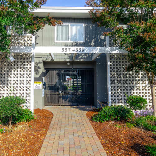 Apartment exterior entrance with gate at Garden Court Apartments in Alameda, California