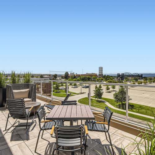 Tables and chairs on the roof deck at Elevation @ County Line Station in Englewood, Colorado