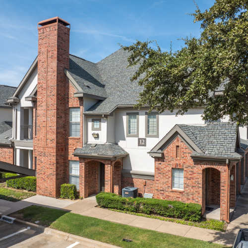 Townhomes with well-manicured landscaping at The Livingston in Plano, Texas