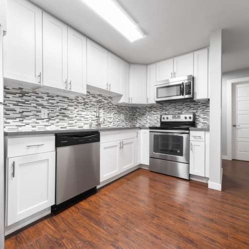 Model kitchen with stainless-steel appliances and wooden cabiets at Lantera Apartments in Seattle, Washington