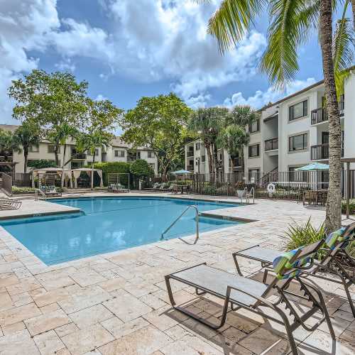 Lounge chairs by the pool at Cascades at the Hammocks in Miami, Florida