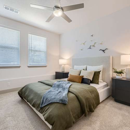 Bedroom with bright windows and a ceiling fan at Sorella in Denver, Colorado