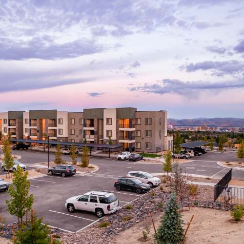 Resident taking care of plants in his living room at The Overlook at Keystone Canyon in Reno, Nevada