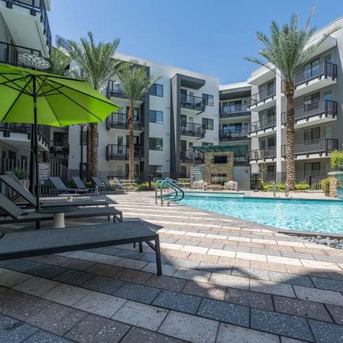 Swimming pool with lounge bed and canopy at Art on Highland in Phoenix, Arizona
