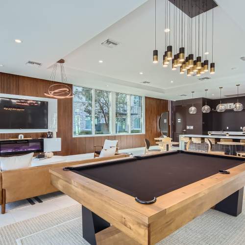Multipurpose clubhouse with large television and seating area at Amelia Apartments in Miami, Florida