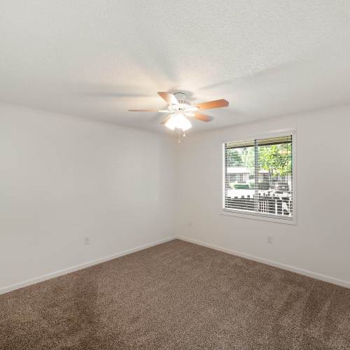 Bedroom with plush carpeting at The Flats at Lakeshore in Fort Oglethorpe, Georgia