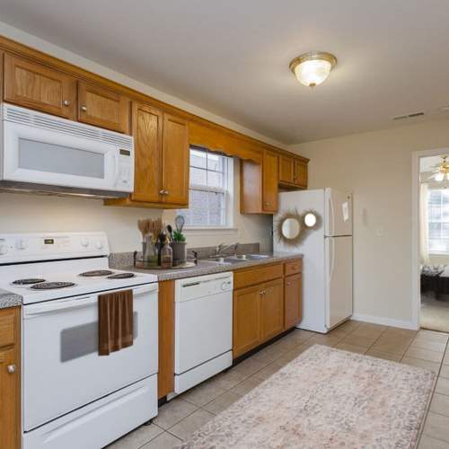 Kitchen with appliances at Home Place Apartments in East Ridge, Tennessee