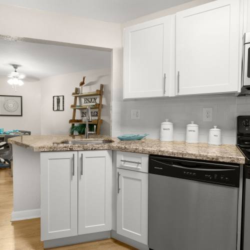 Vibrant kitchen with wooden style flooring and microwave at Emerald Palms in Miami, Florida