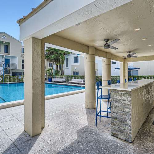 Swimming pool and sun loungers by the poolside at Ludlam Point in Miami, Florida