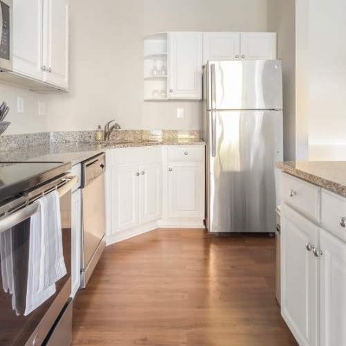 Kitchen with wood cabinetry and modern appliances at Village at Lake Wylie in Lake Wylie, South Carolina