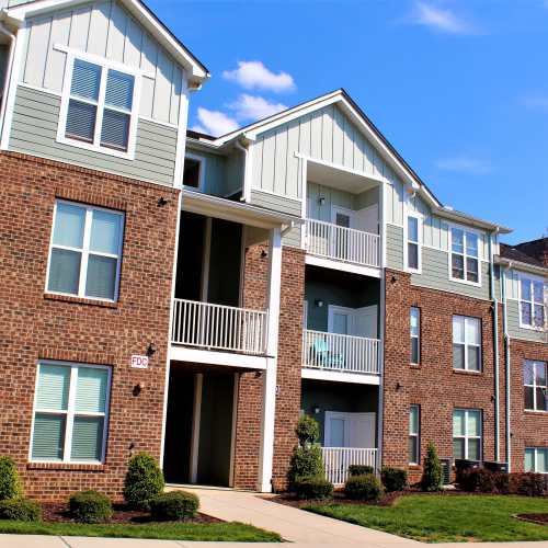 Apartment community exterior with landscaped grounds at South Fork Village in Belmont, North Carolina