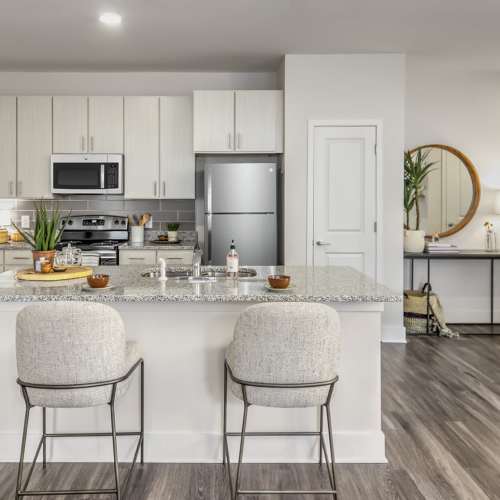 Cozy apartment kitchen with luxury plan flooring and two chairs at Marlowe Place in Charlotte,North Carolina