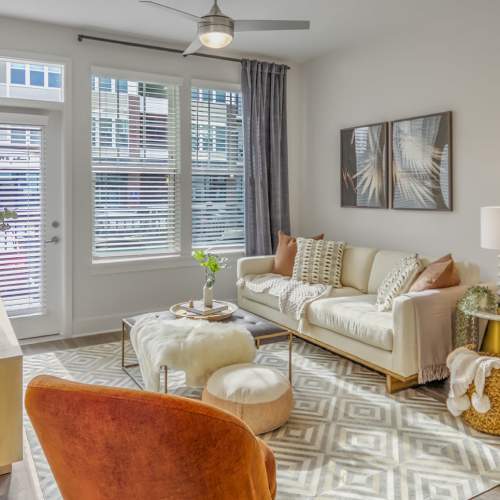 Bright living room with cream accent furniture at Marlowe Place in Charlotte,North Carolina