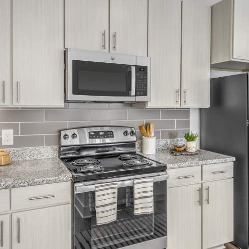 Apartment kitchen with stainless-steel appliances including refrigerator and cabinetry at Marlowe Place in Charlotte,North Carolina