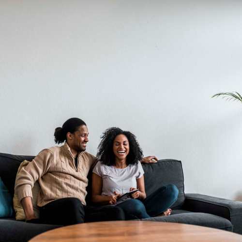 Resident couple relaxing in living room at Landmark at Dublin in Dublin, Pennsylvania