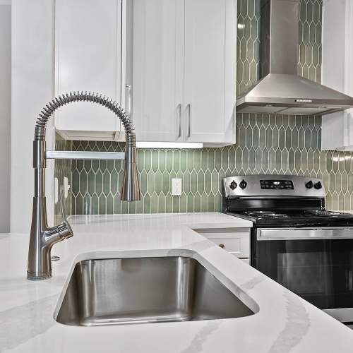 Kitchen close up with white quartz countertops and undermount sink