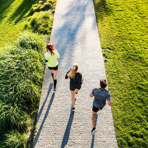 Resident doing morning run in park trek near Greer Mill Residences in Greer, South Carolina