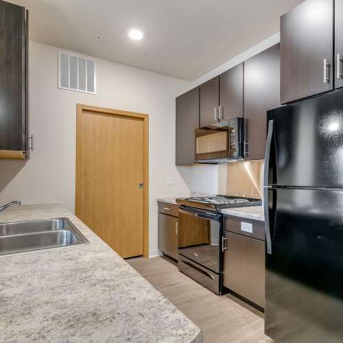 View of the modern kitchen with fridge at Eva Manor in Pleasant Prairie, Wisconsin