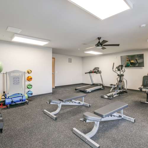 Community fitness center with a ceiling fan at Whitetail Ridge in Salem, Wisconsin