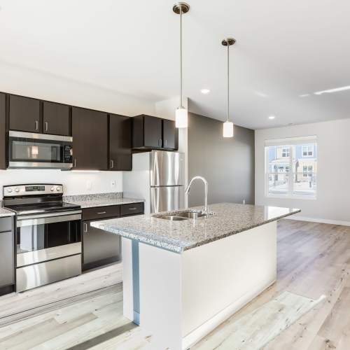 Kitchen with island and hanging light at Union Court Senior Apartments and Townhomes in Kenosha, Wisconsin
