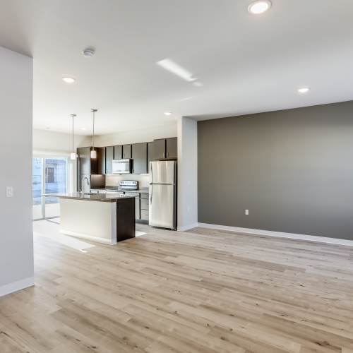 Kitchen with attached unfinished living room at Union Court Senior Apartments and Townhomes in Kenosha, Wisconsin 